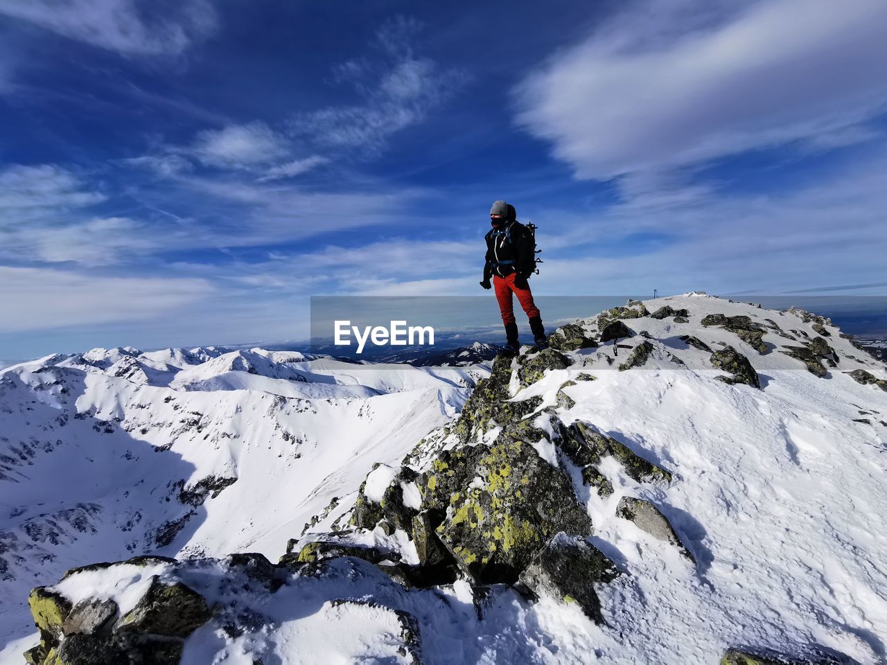 Full length of person on snowcapped mountain against sky