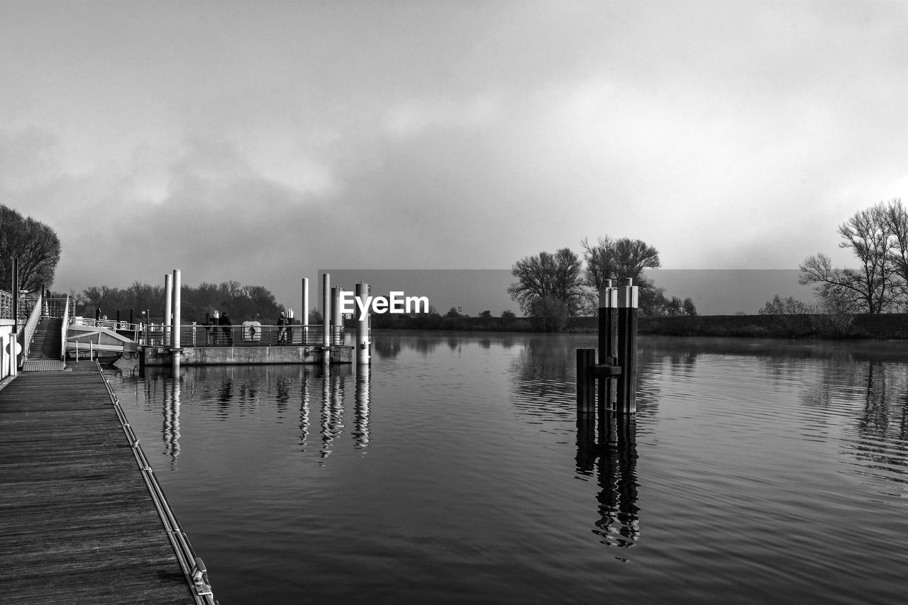 PANORAMIC VIEW OF WOODEN POST IN LAKE AGAINST SKY