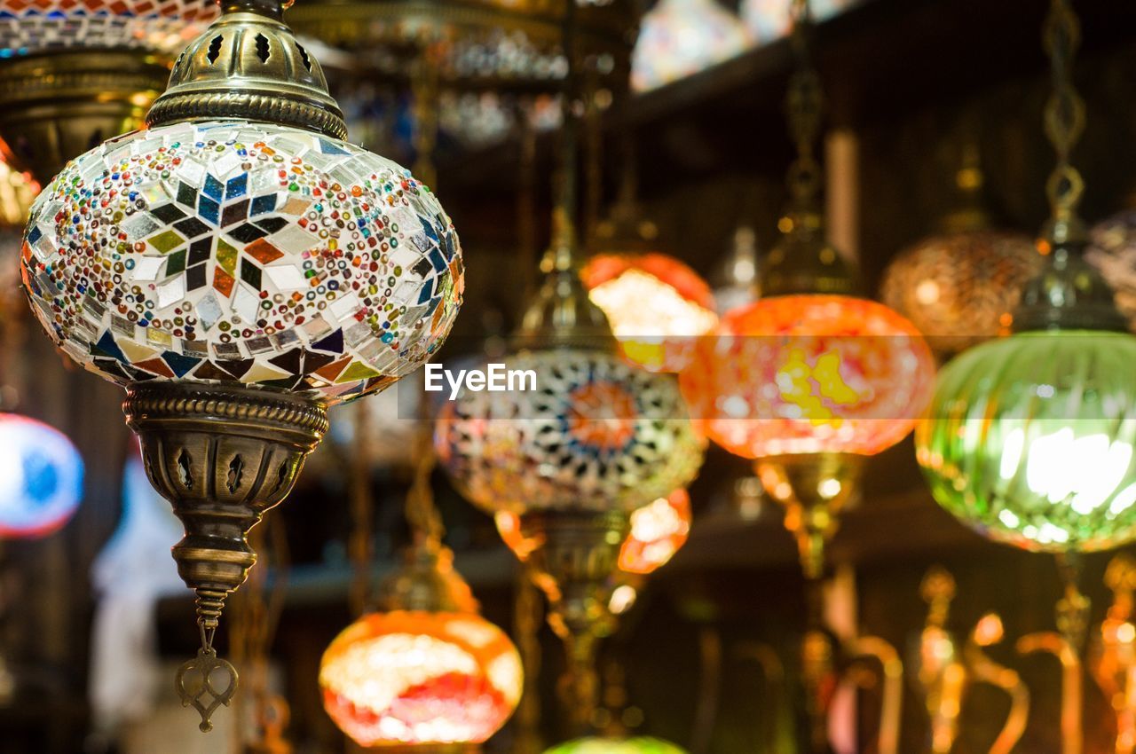 Close-up of illuminated lanterns hanging at store