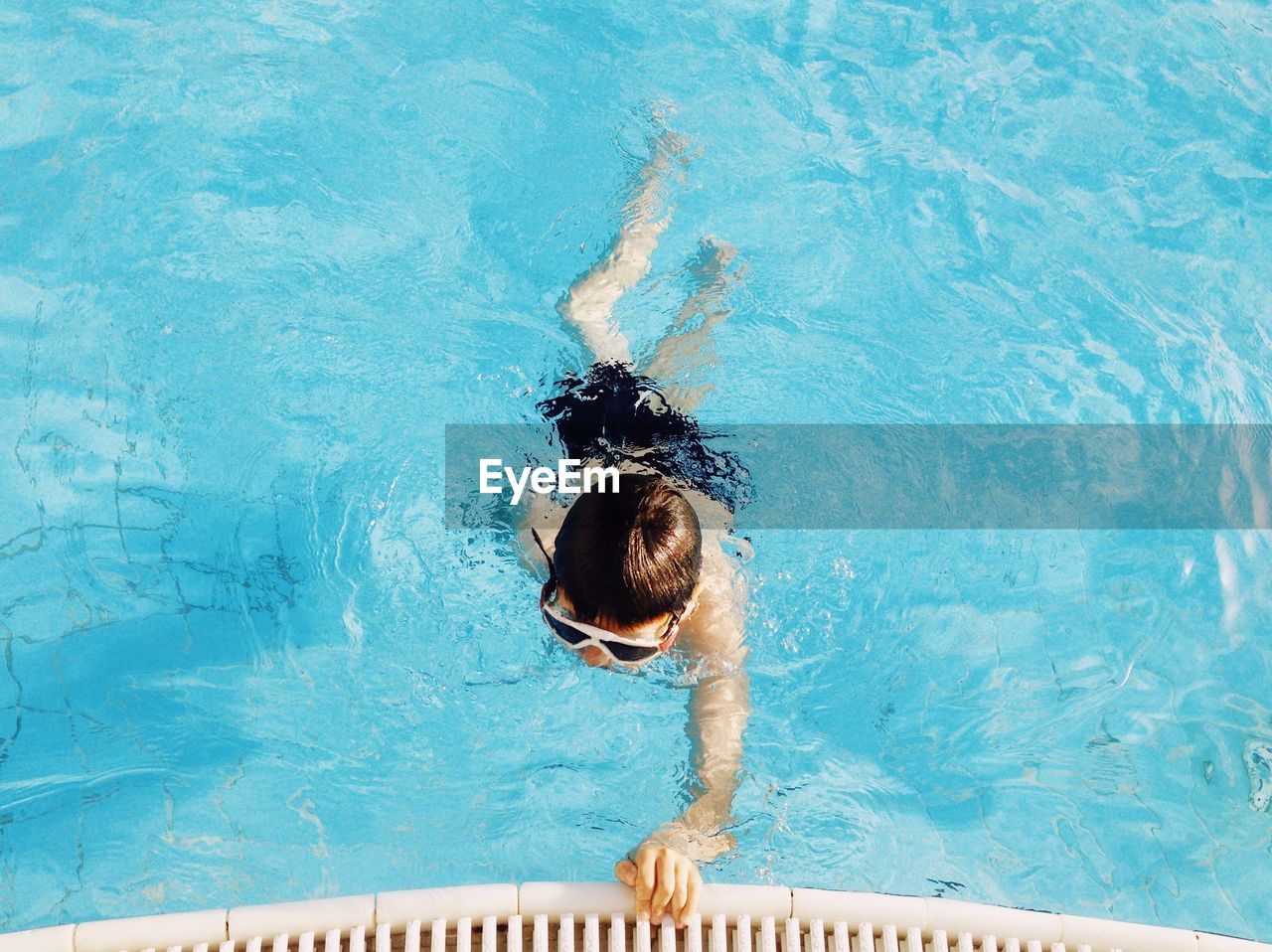 High angle view of boy swimming in pool