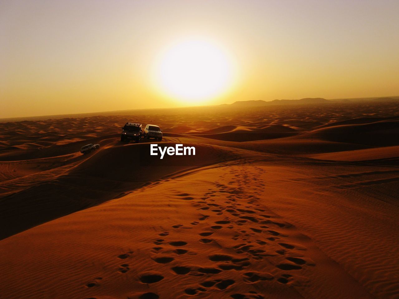 Scenic view of desert against sky during sunset