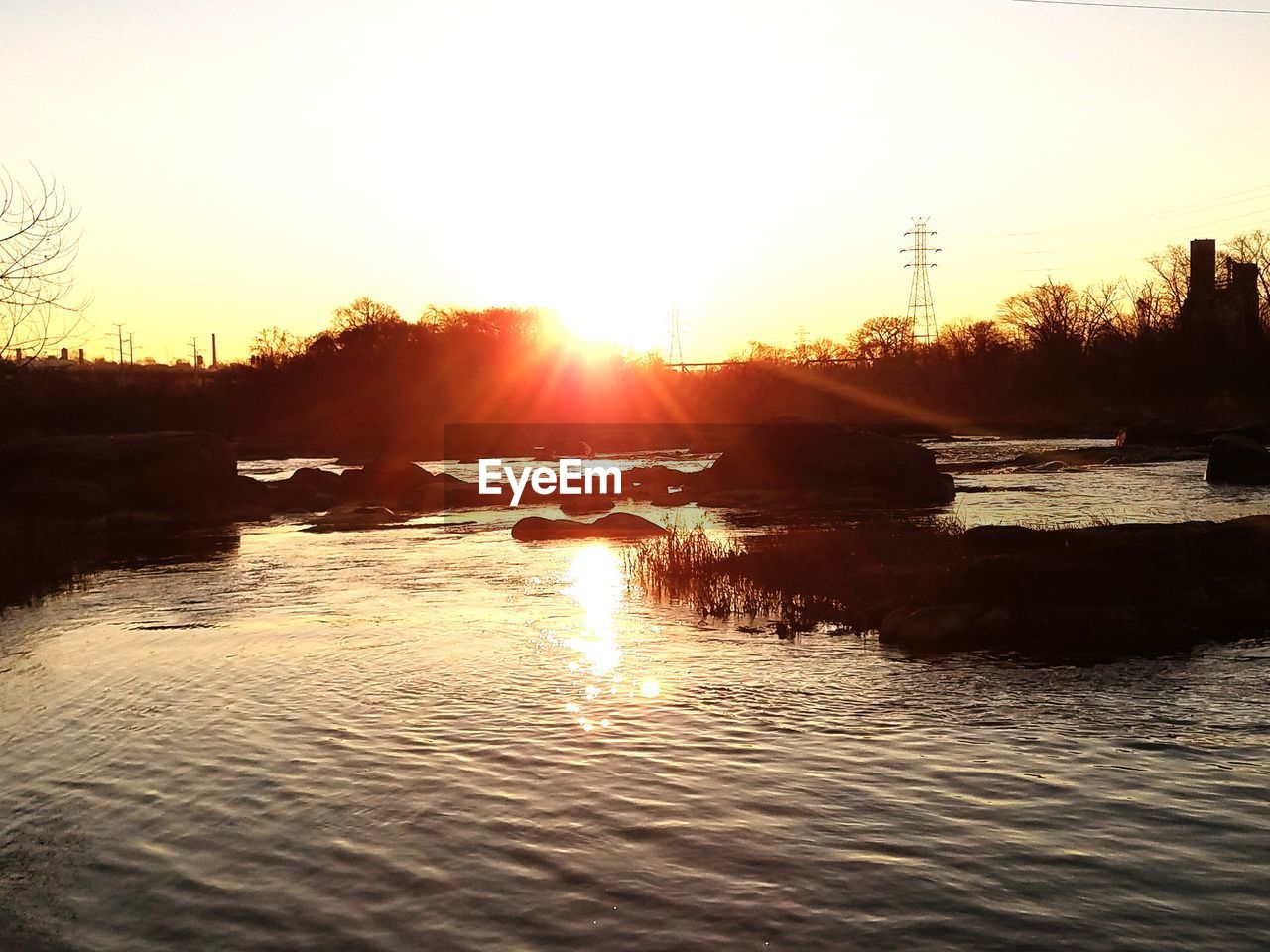 SCENIC VIEW OF RIVER AGAINST SKY AT SUNSET