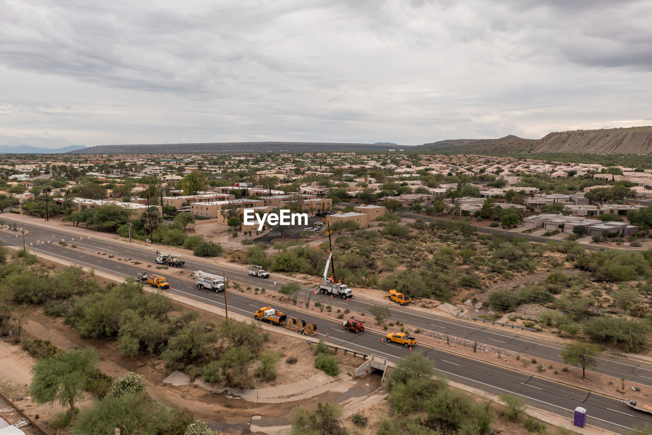 HIGH ANGLE VIEW OF ROAD ALONG CITYSCAPE