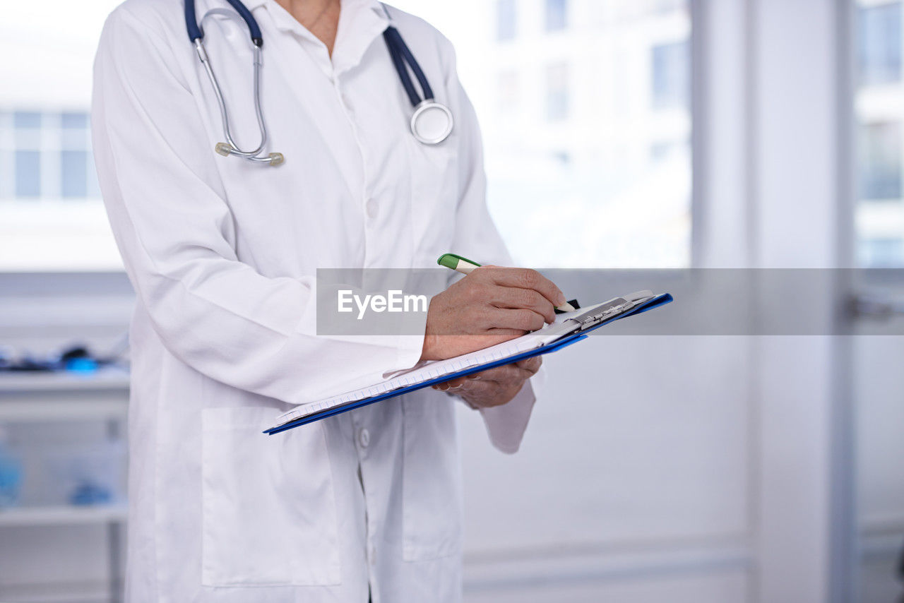 midsection of doctor examining x-ray