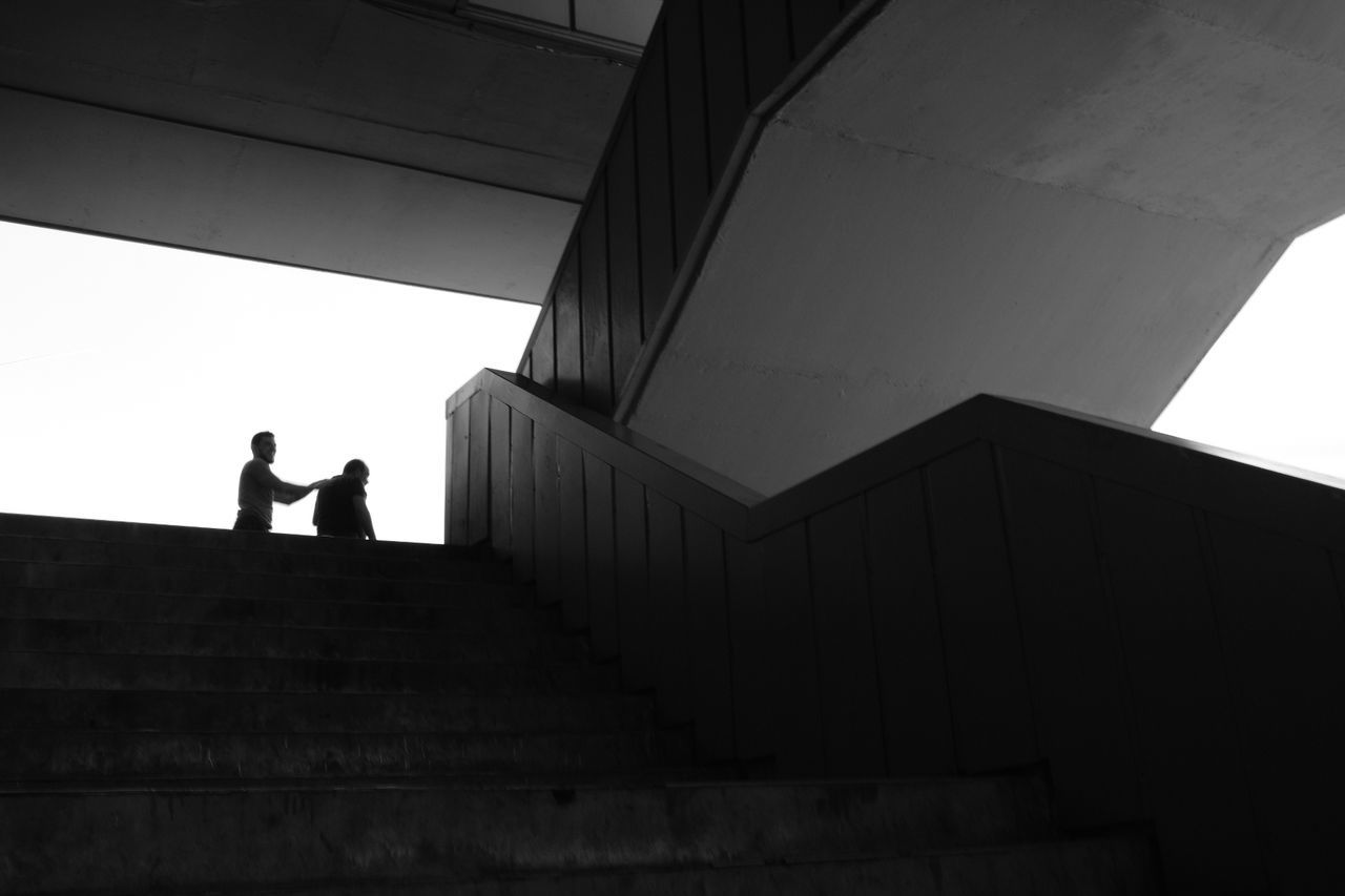 Silhouette people standing on staircase of building