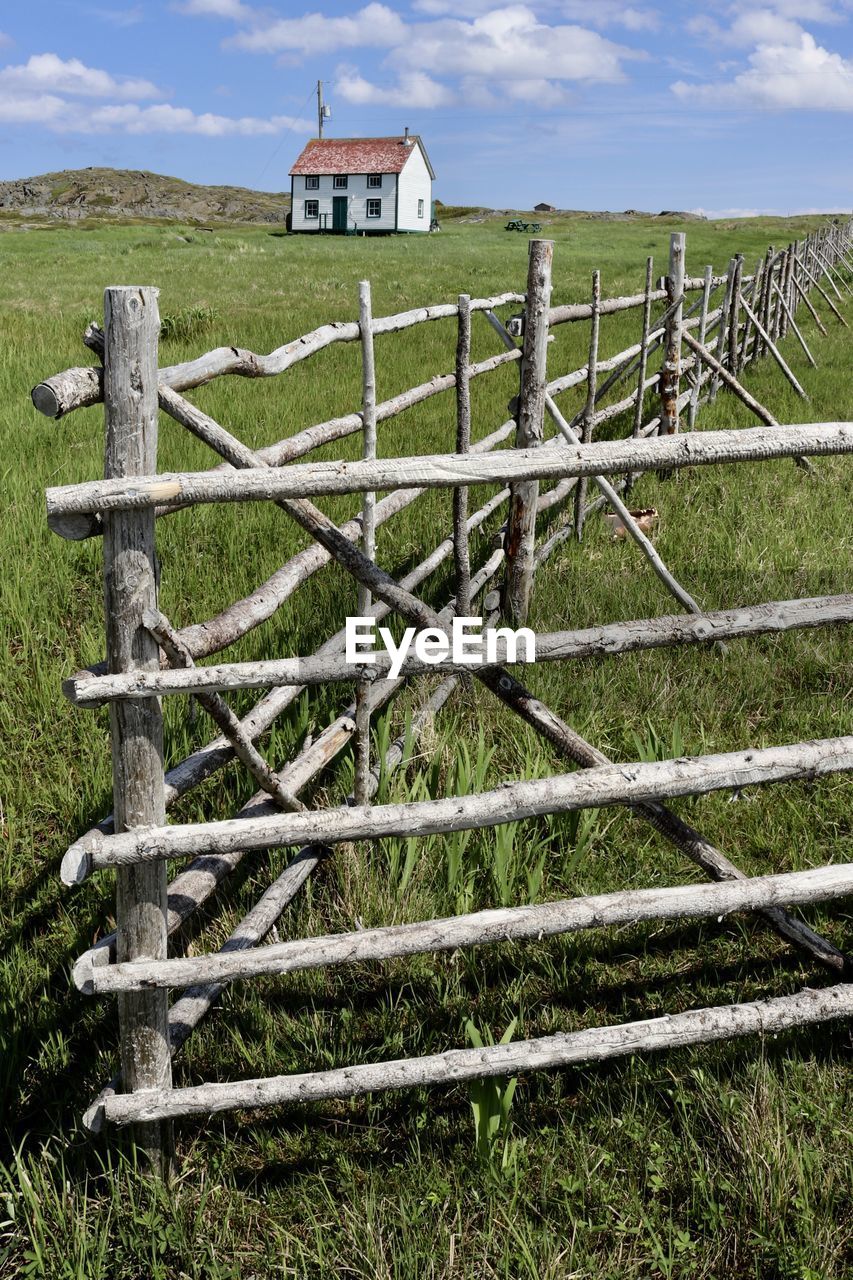 Fence on field against sky