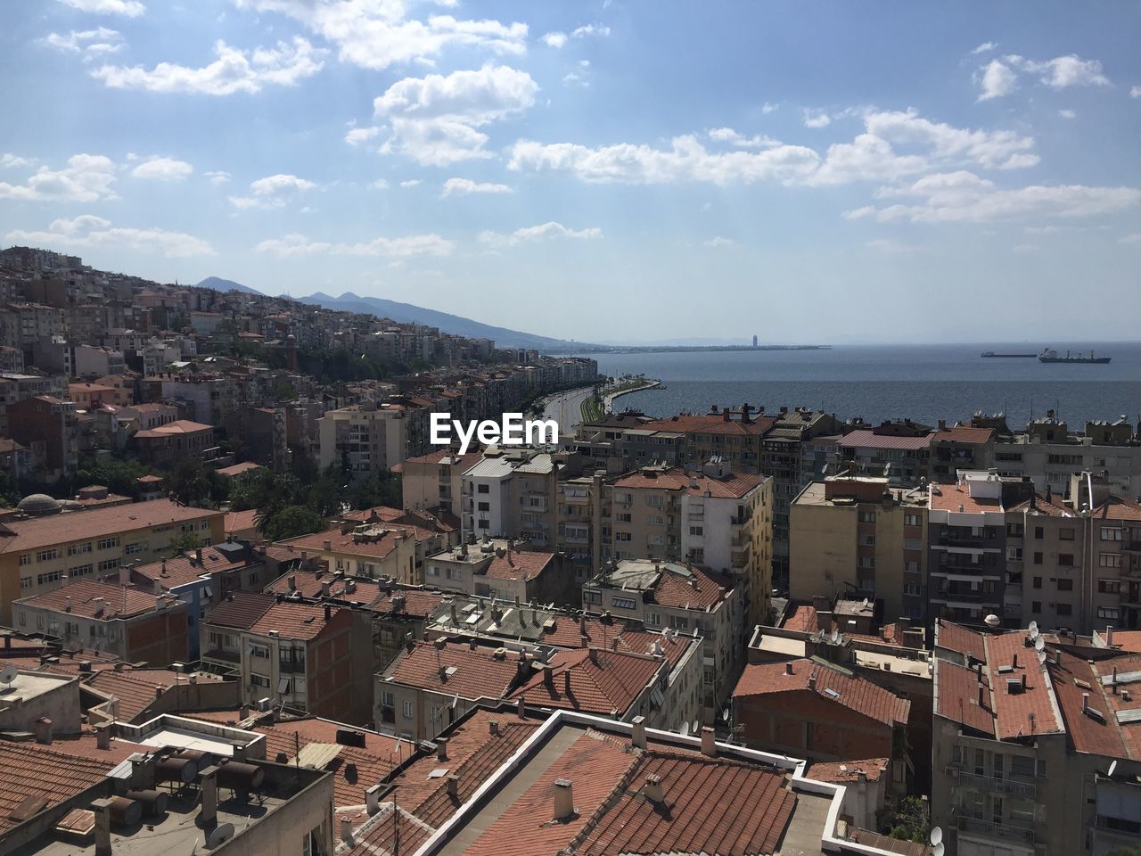 High angle view of townscape by sea against sky