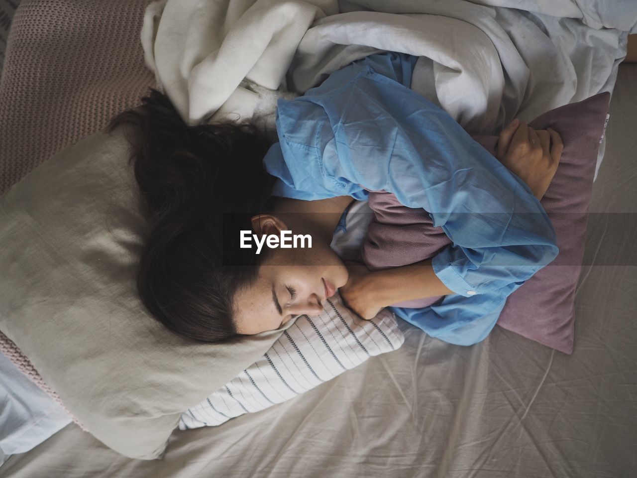 High angle view of woman lying on bed