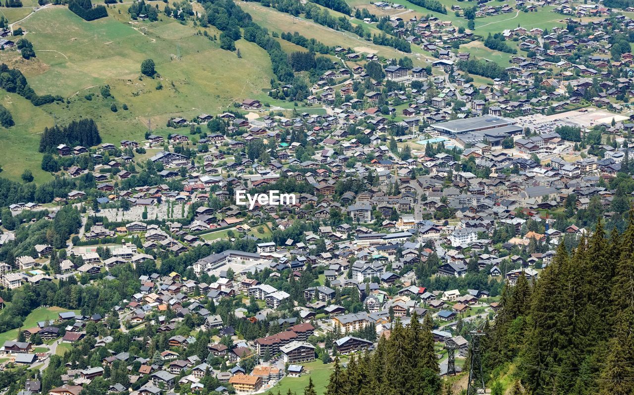 High angle view of townscape and felds next to a city of megève in france. 