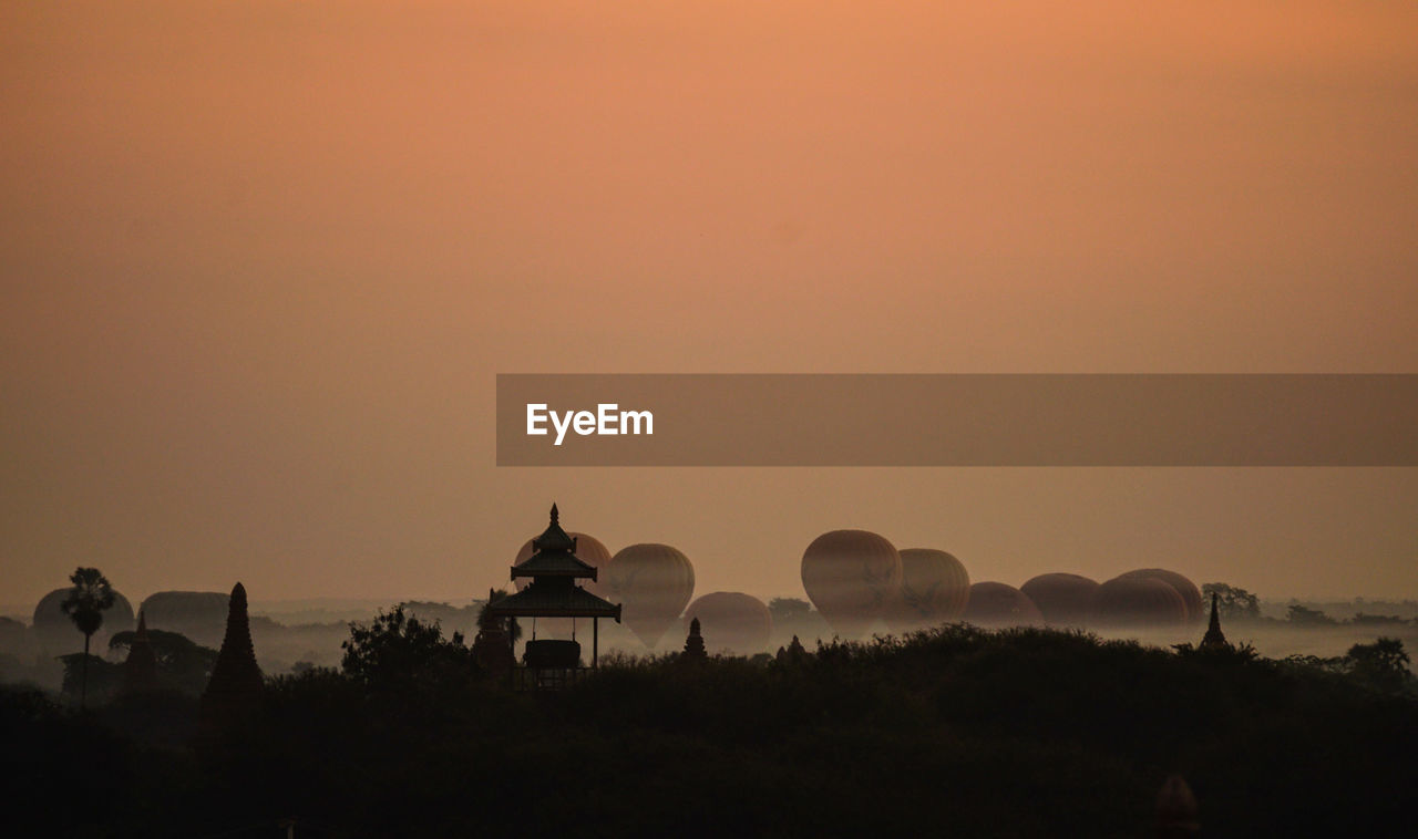 Hot air balloons against sky during sunset