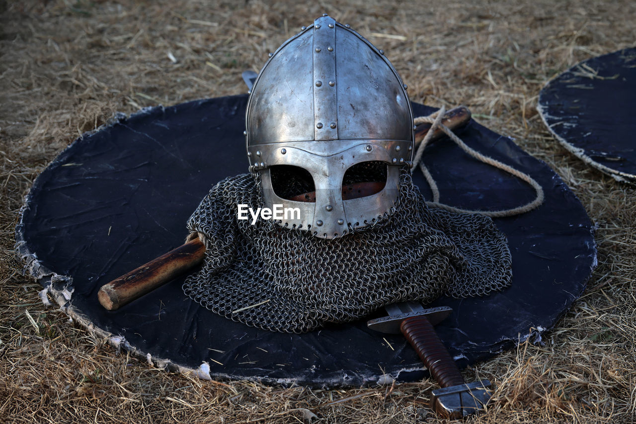 Part of the iron armor, the helmet, the shield and the sword used in mock fights during the event.