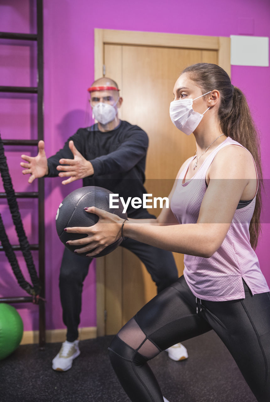 Training with personal trainer and covid19 virus protection masks