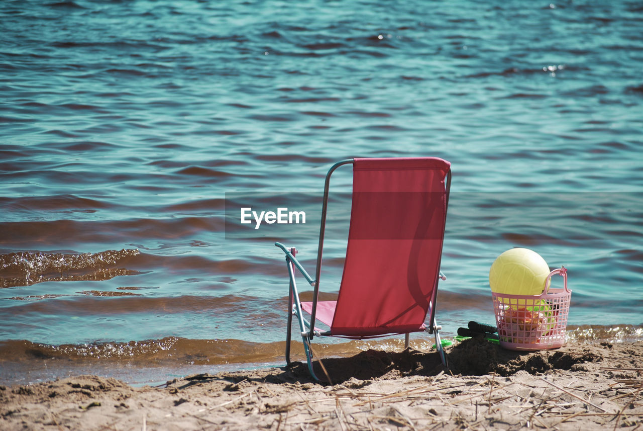 Chair on shore at beach