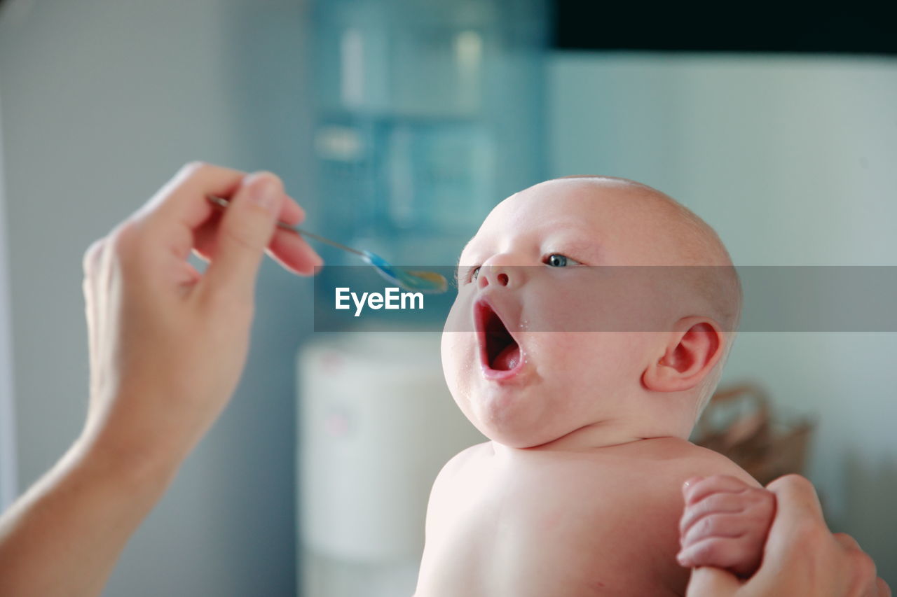 Close-up of shirtless baby eating