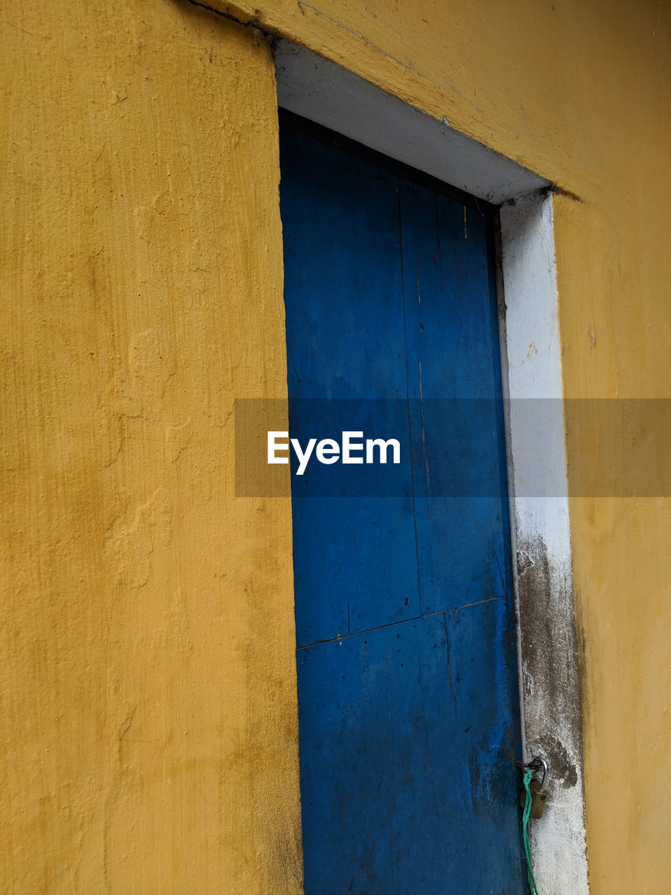 Blue door, yellow wall, streets of hoi an, vietnam.