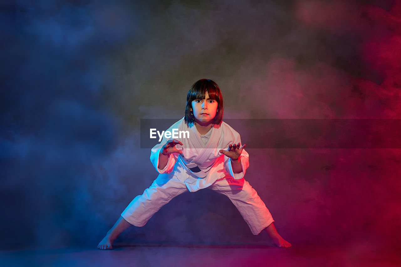 Elementary school girl, in kimono, practicing martial arts 