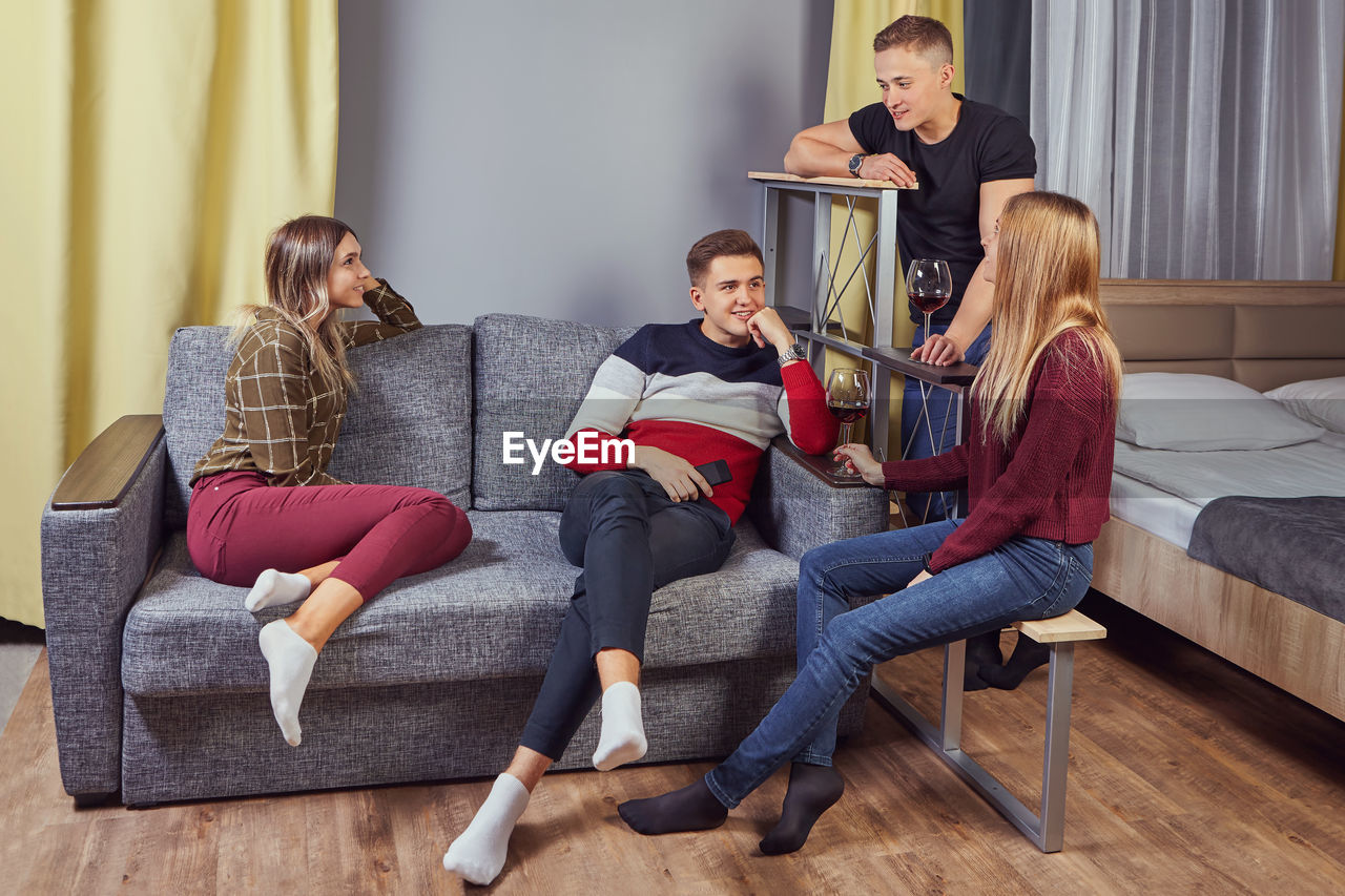 People sitting on sofa at home