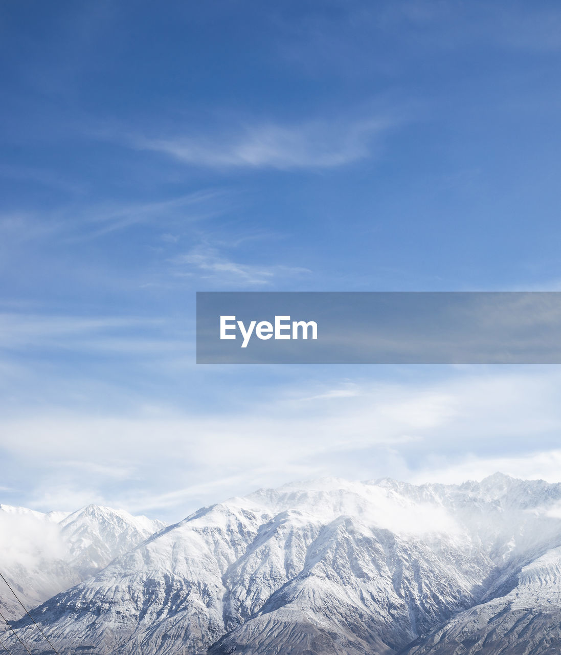 SCENIC VIEW OF SNOWCAPPED MOUNTAINS AGAINST SKY DURING WINTER