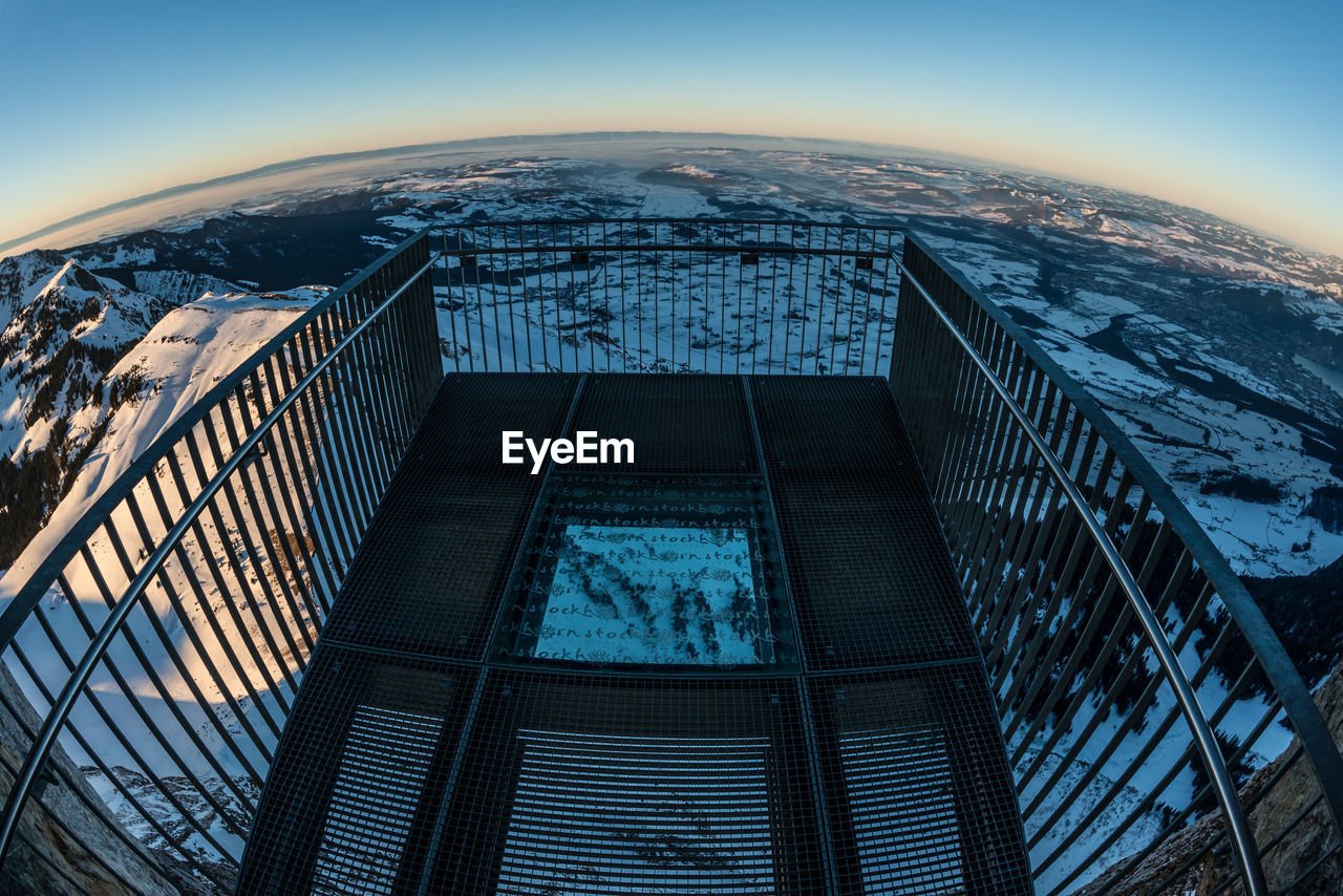 HIGH ANGLE VIEW OF BUILDINGS SEEN THROUGH RAILING