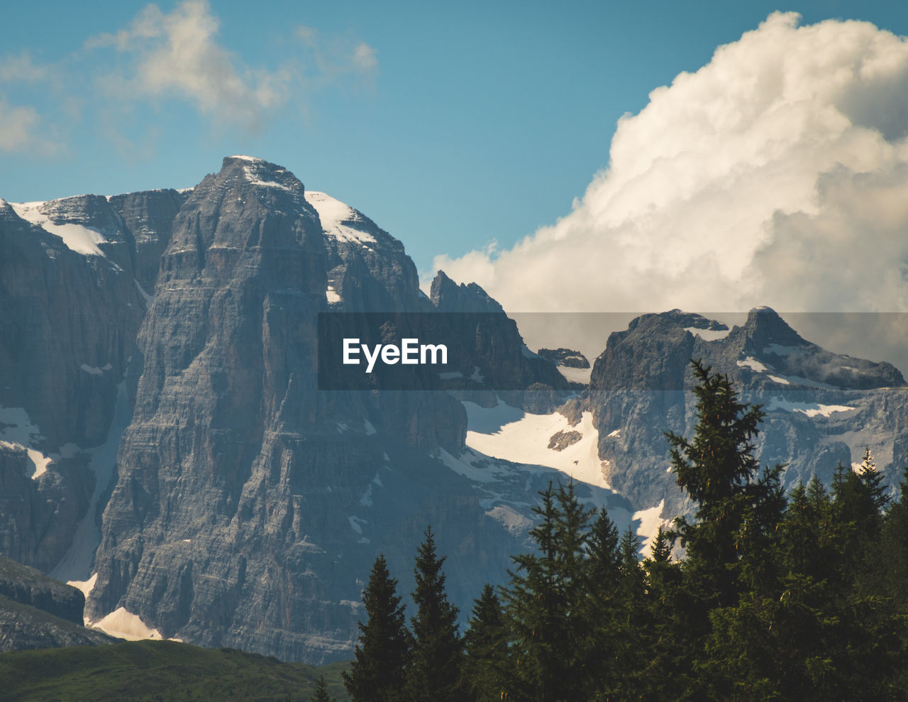 Snow capped peaks of cloud shrouded rocky mountains