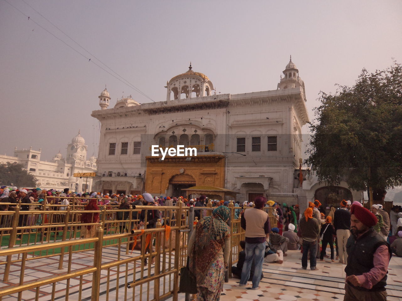 People at golden temple against sky