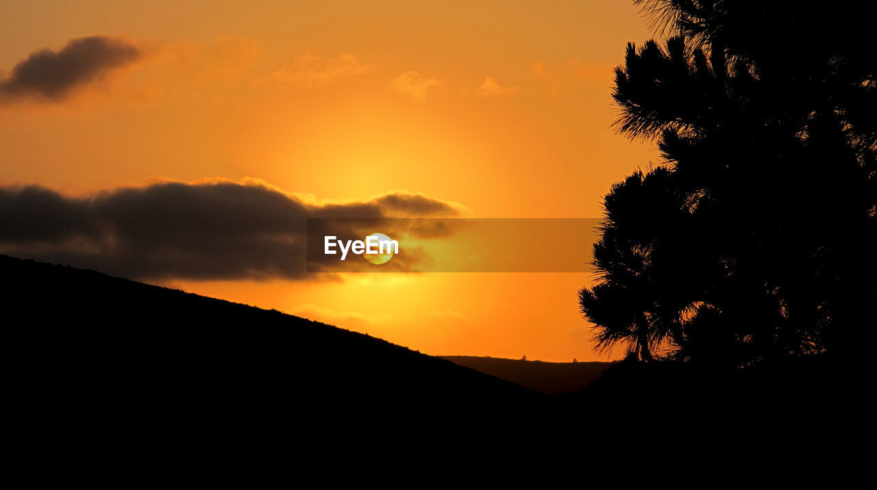 Scenic view of mountains at sunset