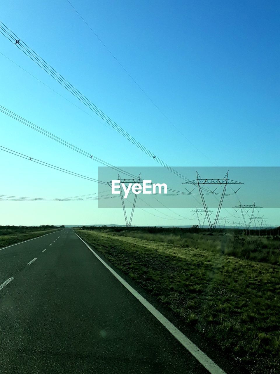 ROAD AMIDST FIELD AGAINST SKY