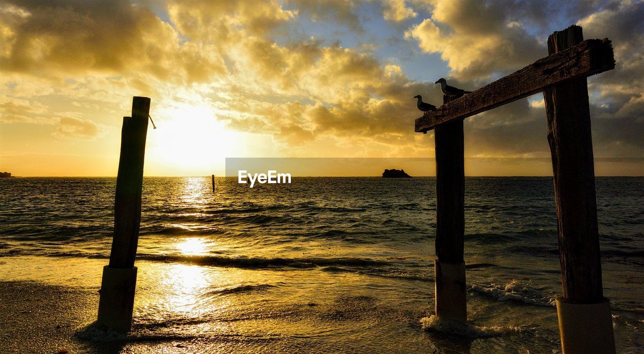 SCENIC VIEW OF CALM SEA AGAINST SKY DURING SUNSET