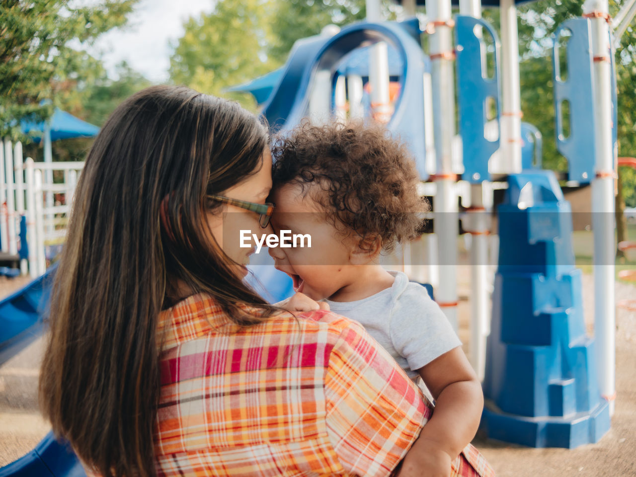 Mother and son embracing in park