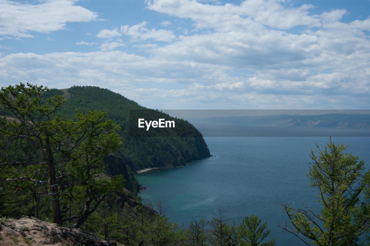 Scenic view of sea and mountains against sky