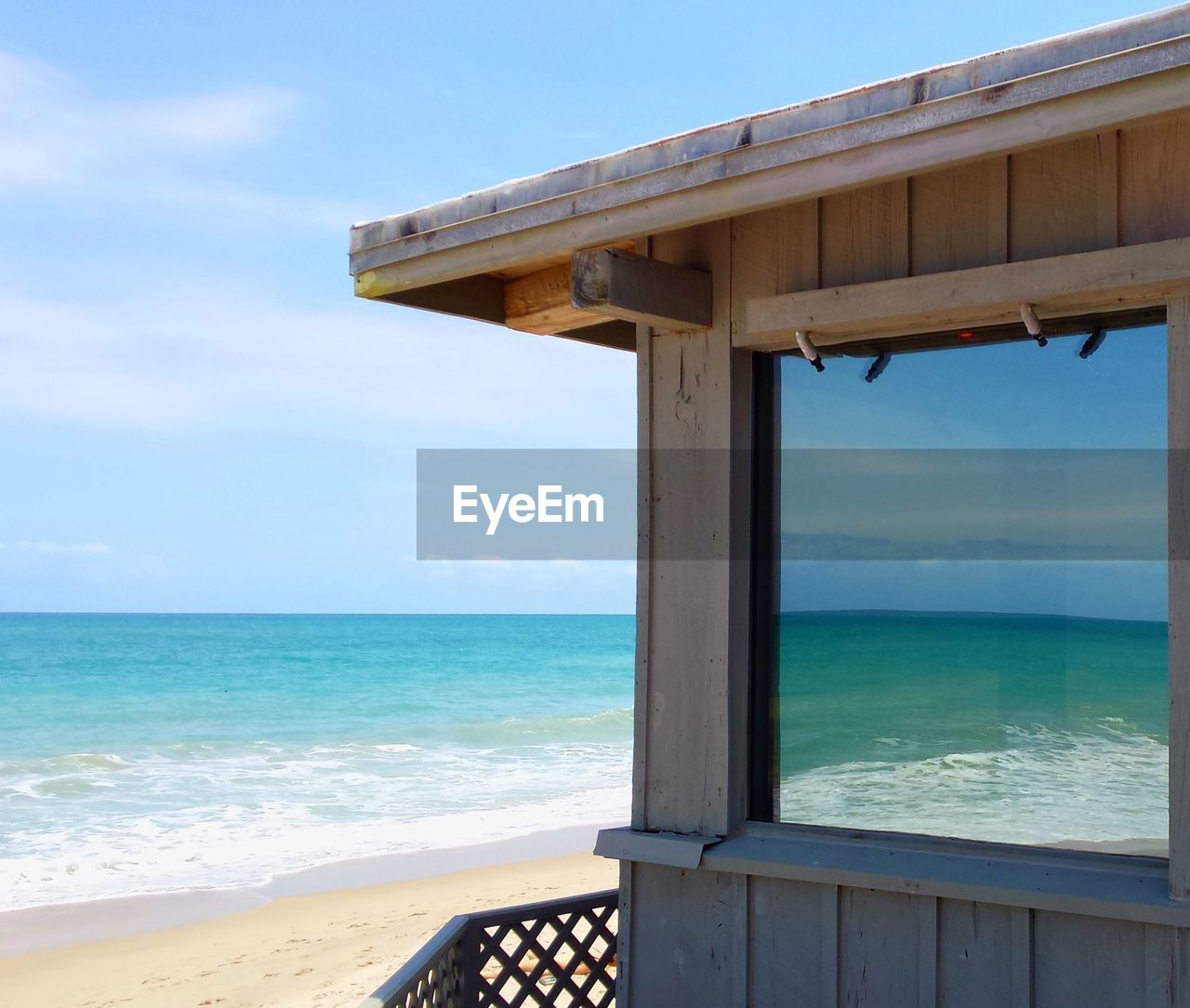 Cropped image of hut at beach against sky