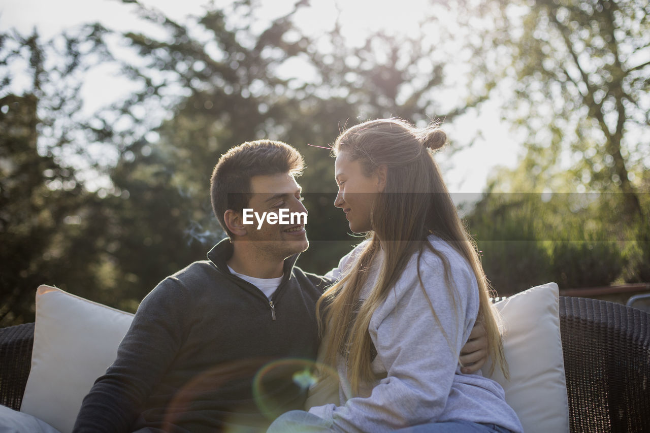 Smiling couple sitting in yard