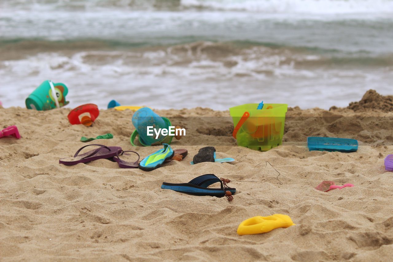 Buckets and flip-flops at beach