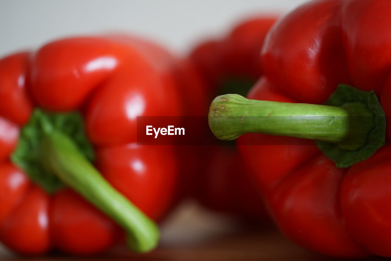 CLOSE-UP OF RED BELL PEPPERS IN CONTAINER