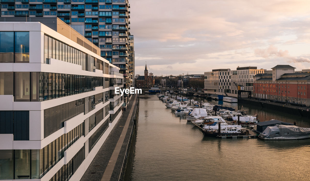 Buildings in city against cloudy sky