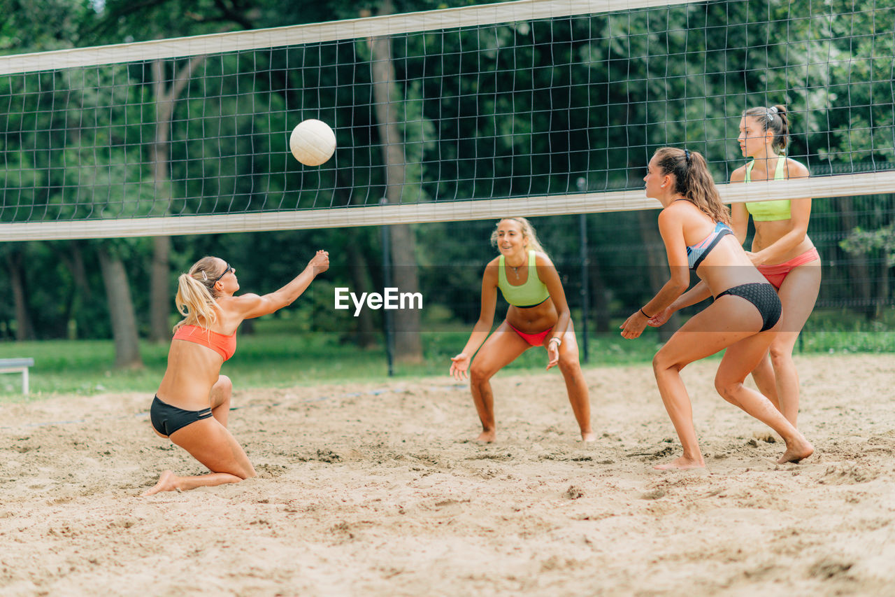 Young women playing beach volleyball