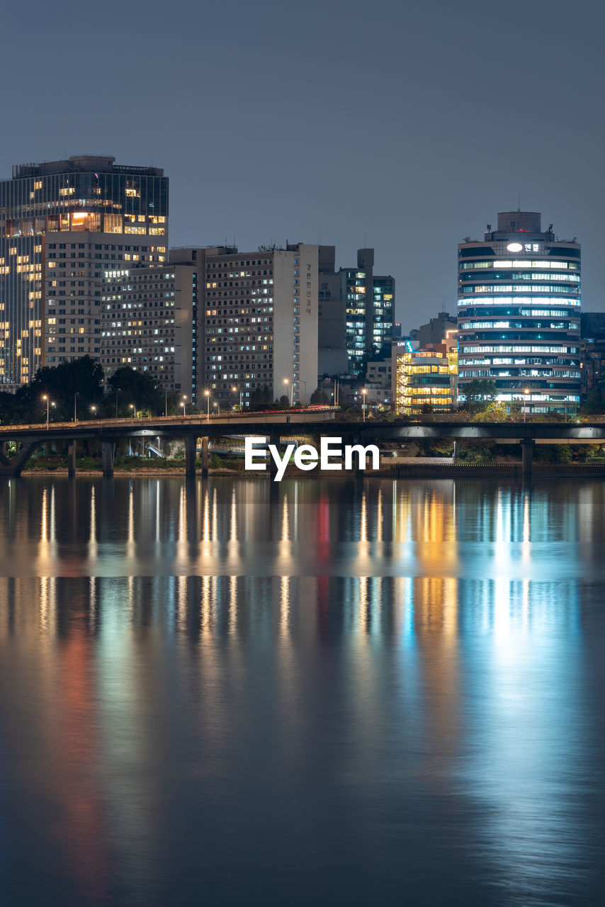 illuminated buildings in water