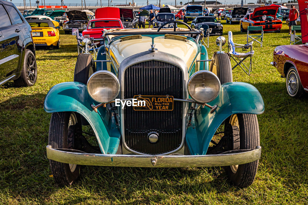 VINTAGE CAR PARKED IN FIELD