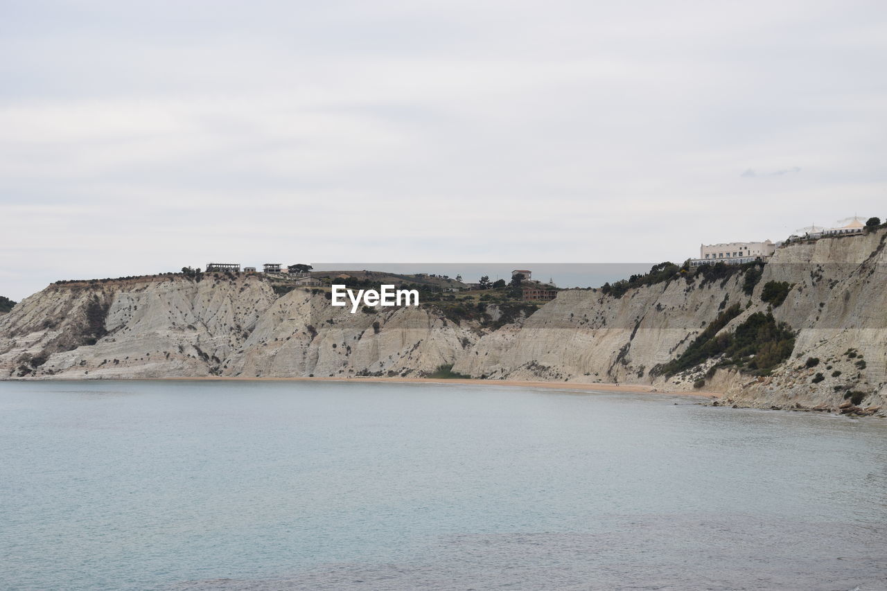 SCENIC VIEW OF CLIFF BY LANDSCAPE AGAINST SKY