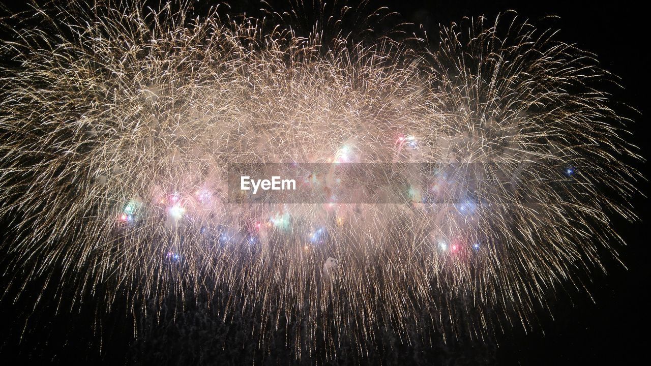 LOW ANGLE VIEW OF FIREWORKS DISPLAY