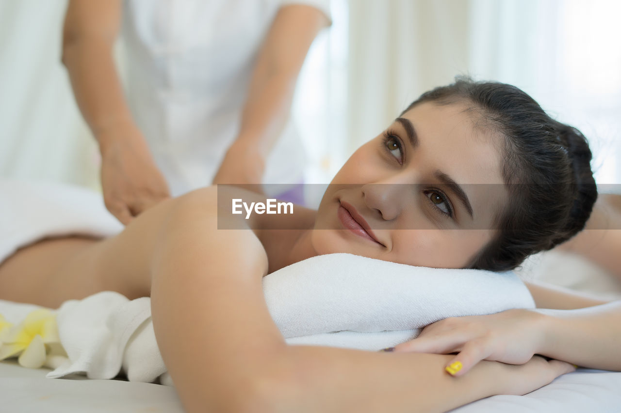 Young woman receiving massage in spa