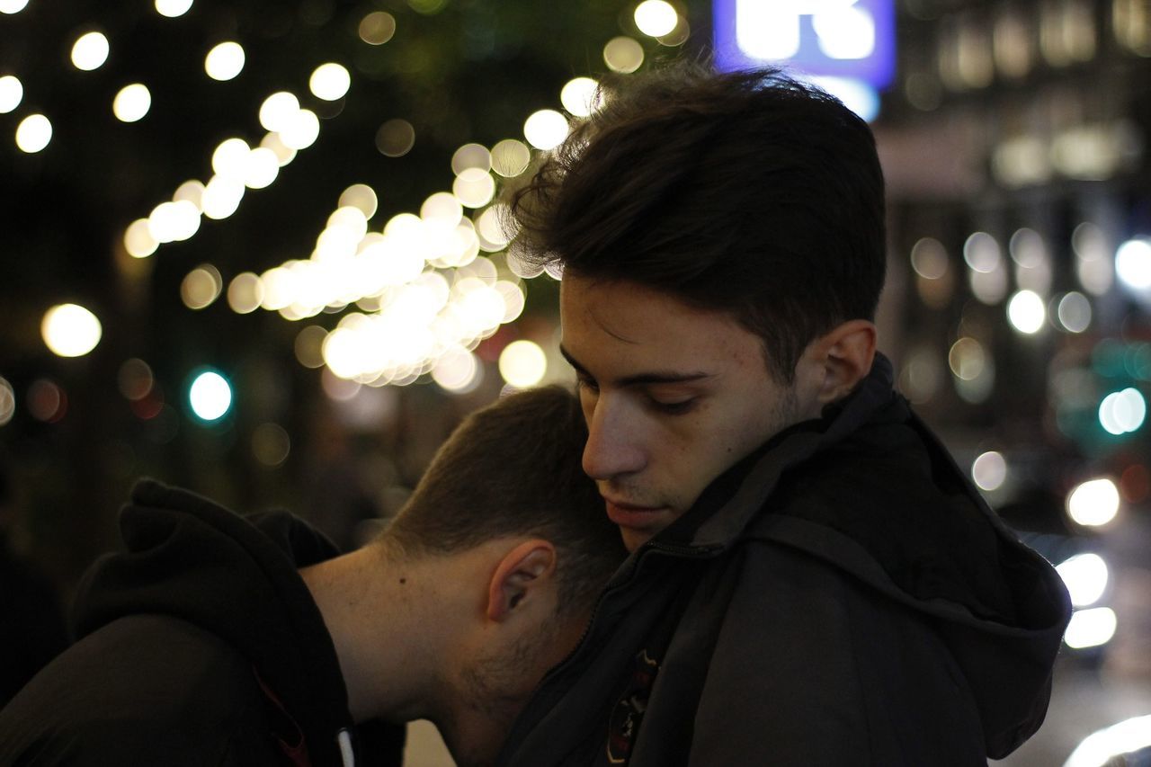 YOUNG COUPLE KISSING IN CITY