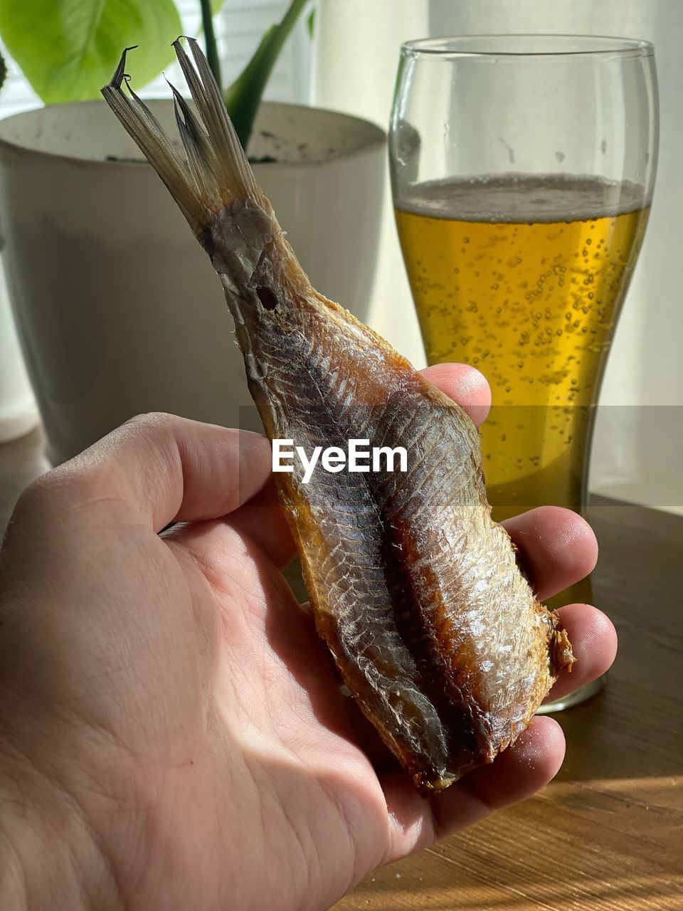 cropped hand of man holding drink