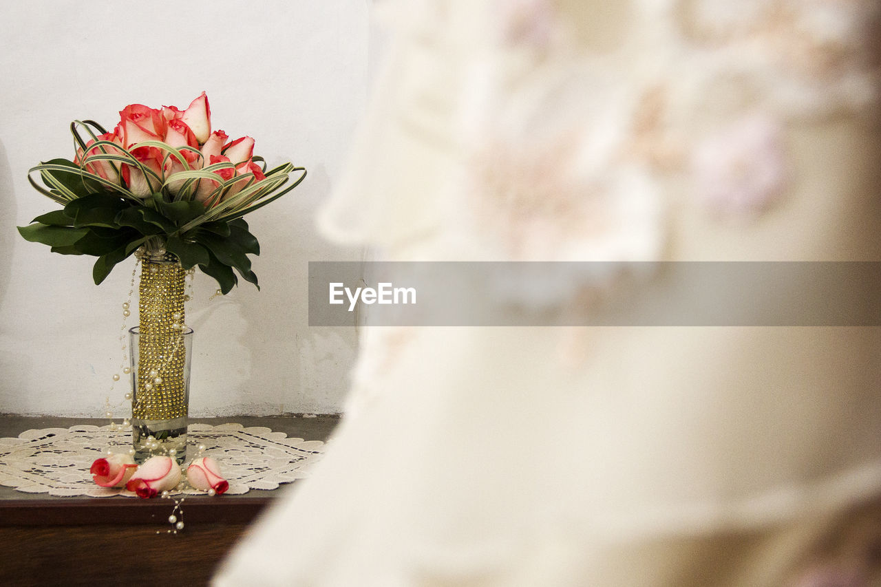 CLOSE-UP OF ROSE BOUQUET ON TABLE