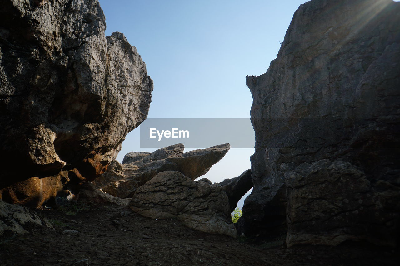 Low angle view of rock formation against sky