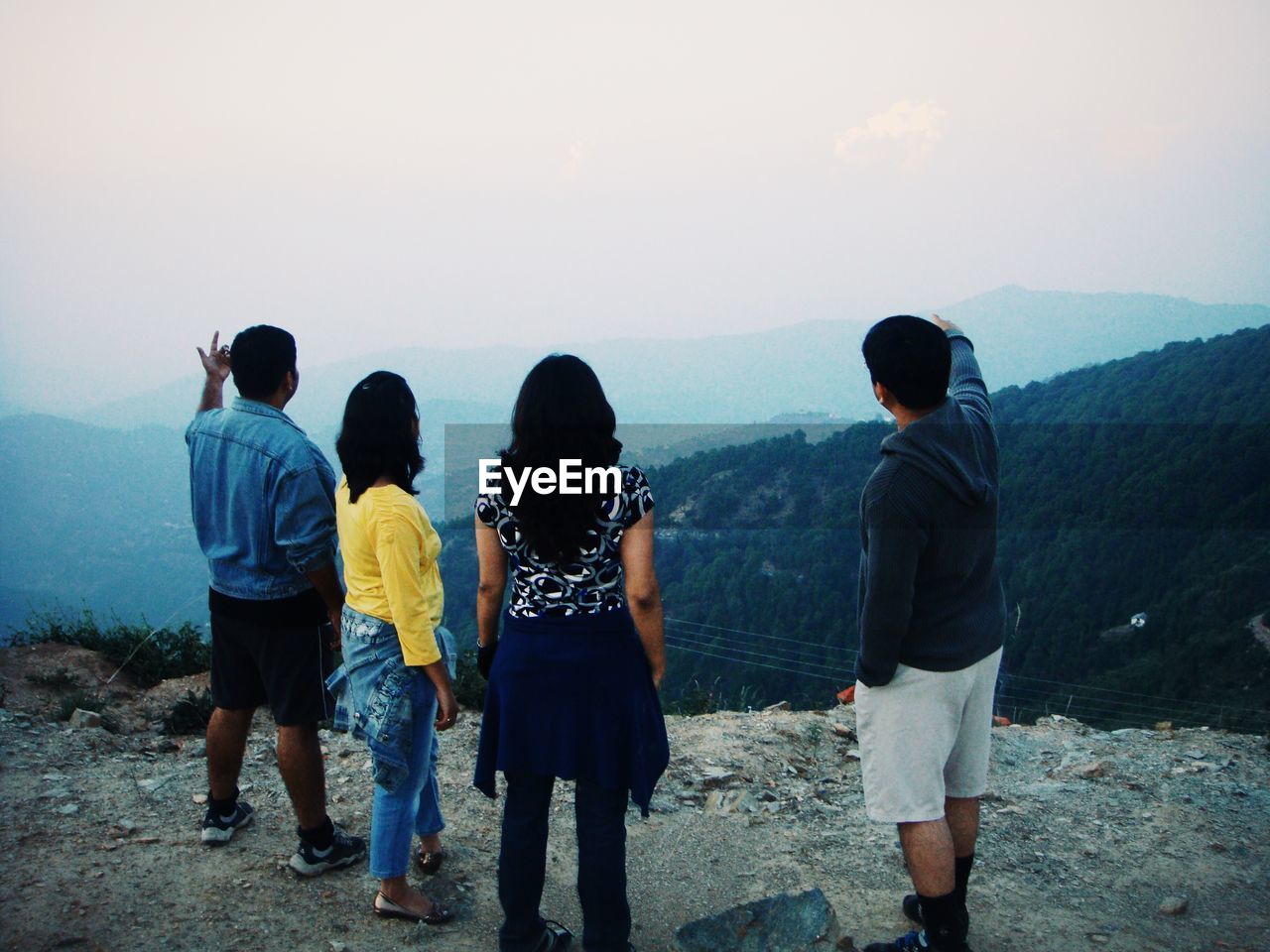 Rear view of couple standing on mountain