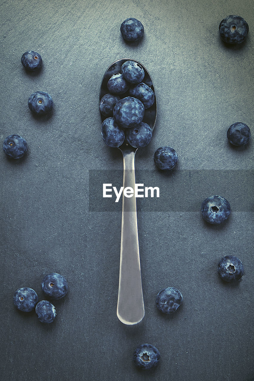 Artistic still life of spoon with blueberries