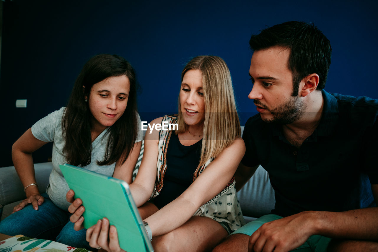 YOUNG COUPLE LOOKING AT TWO PEOPLE