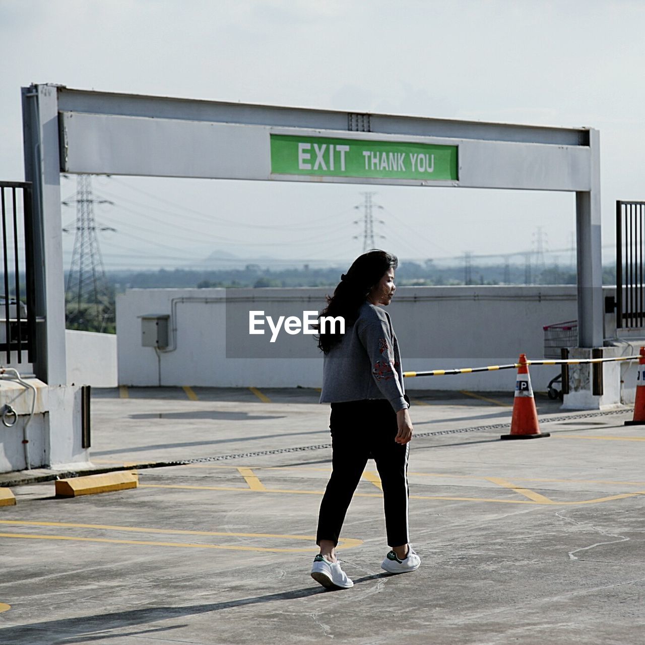 WOMAN STANDING ON ROAD WITH TEXT