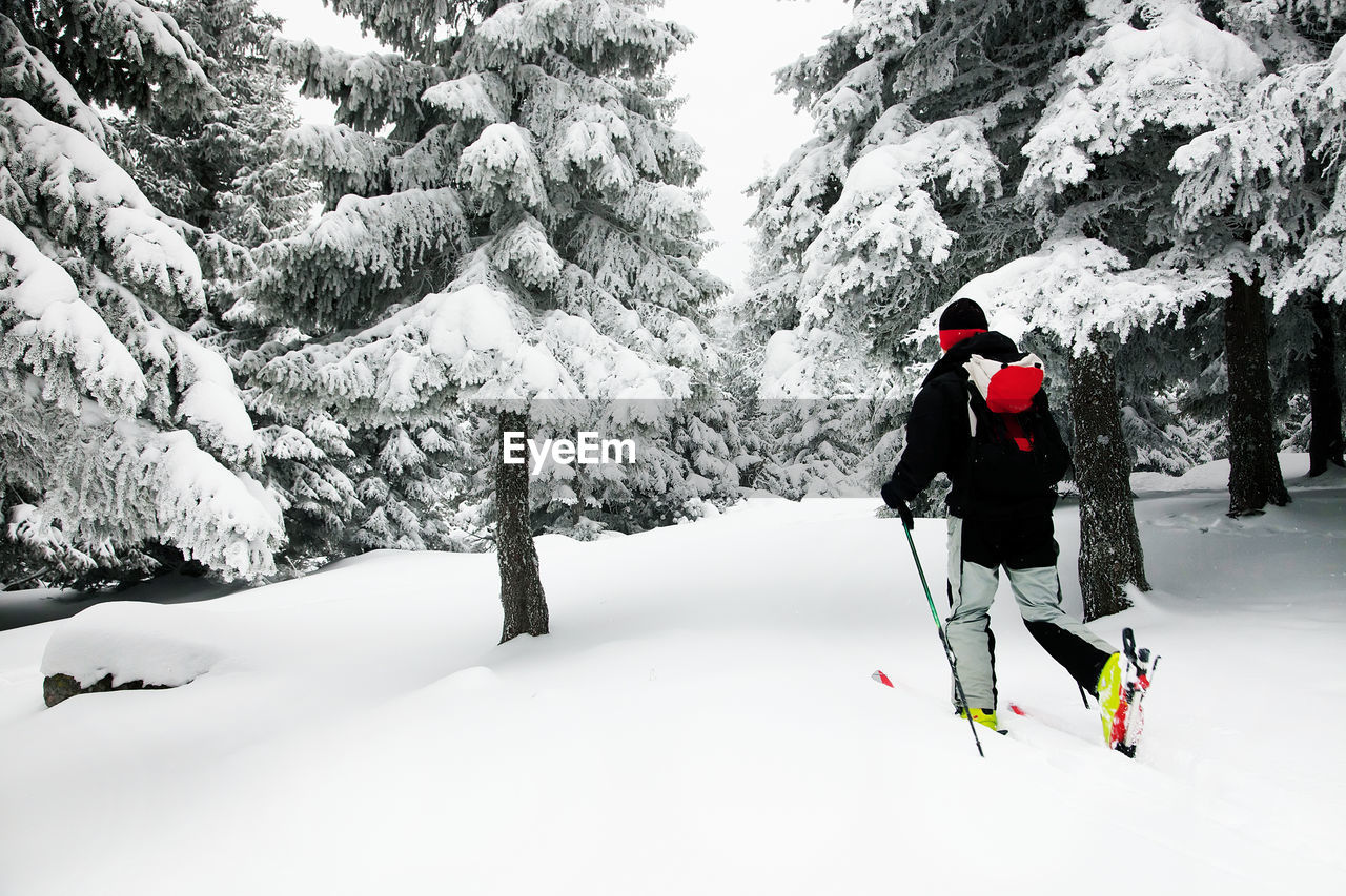 Man skiing on snow covered field